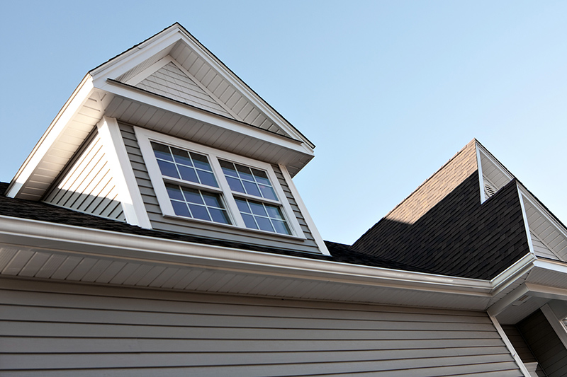 Close up view of a newly built house rooftop soffit and dormers captured during 4-point inspection services
